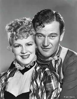 Classic Portraits Collection: Claire Trevor and John Wayne in John Fords Stagecoach (1939)
